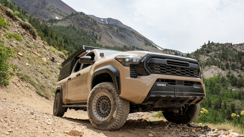 An off-road vehicle with the Nokian Outpost AT All Terrain Tires on a rocky surface