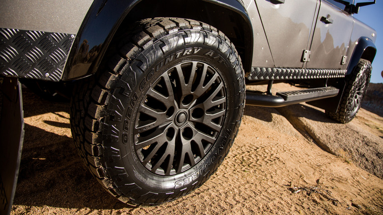 A vehicle with the Toyo Open Country A/T III tires on a dirt surface