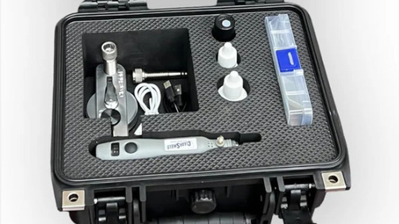 An open case with windshield repair tools