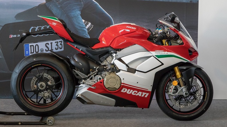 Red and white ducati panigale on wheel stand