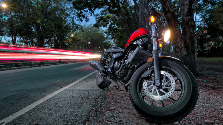 Honda Rebel 300 parked next to a road at dusk