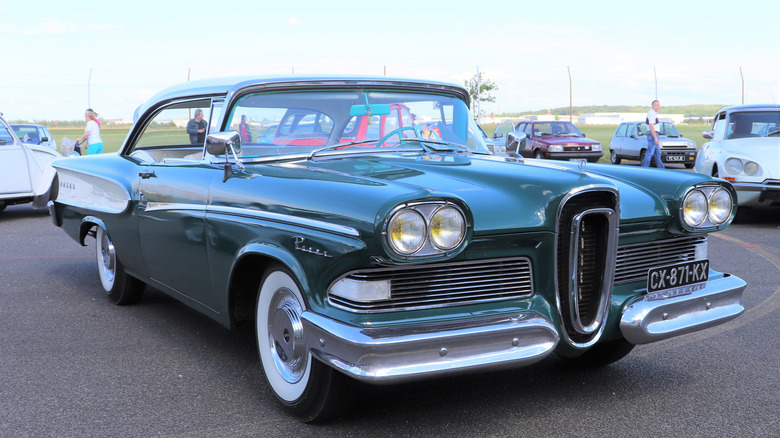 Green and white Edsel Pacer coupe seen from right front parked at outdoor car show