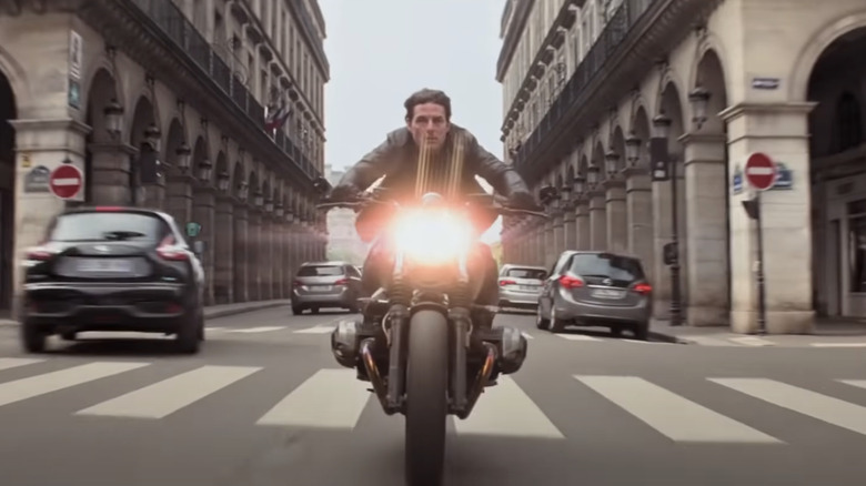 Tom Cruise riding a black BMW R nineT