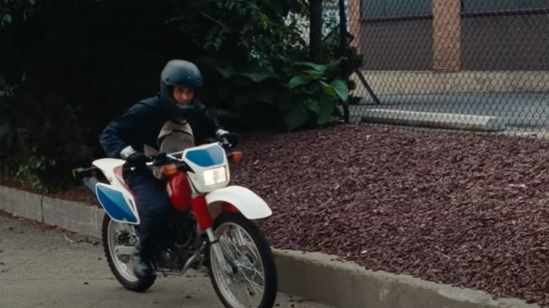 Ryan Gosling riding a white and motorcycle