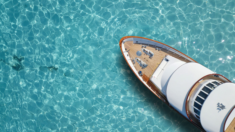 aerial shot of luxury yacht in turquoise water