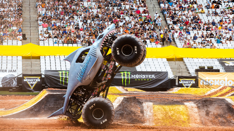 The shark-shaped Megalodon monster truck doing a sky wheelie in front of a crowd in Brazil.