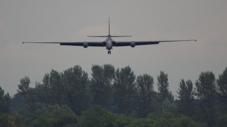 Lockheed U-2 Spy Plane flying low among trees