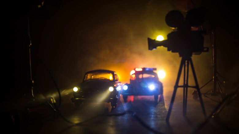 A camera films a nighttime car chase.