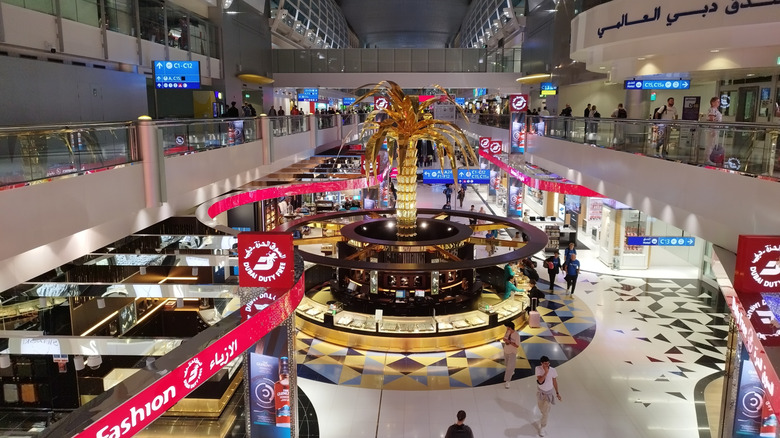 Inside airport with golden palm tree in center