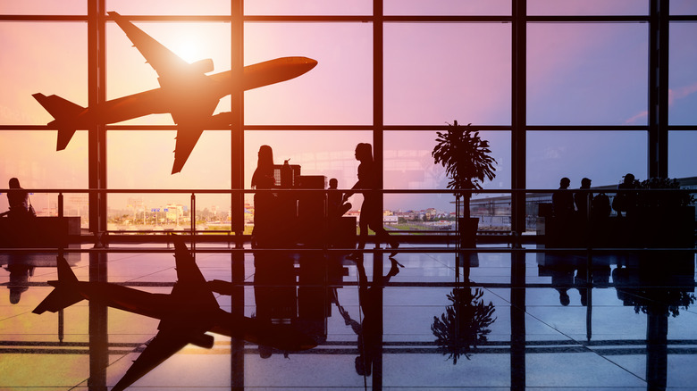 Airport glass wall with a plane in the background