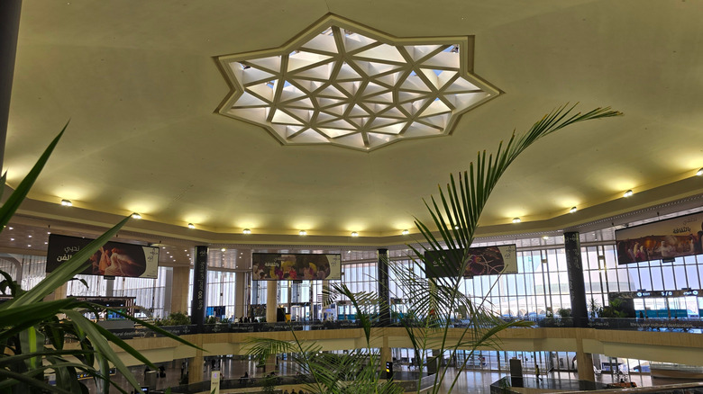 Inside of an airport with octagram design on the roof