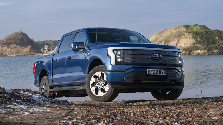 blue Ford F-150 by a lake