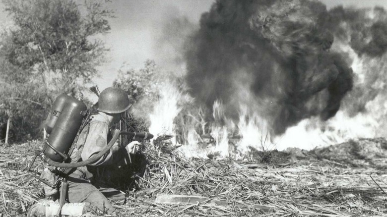 S/Sgt Bill Seklscki fires a flame thrower at a Japanese position near Manacag, Luzon, P.I.