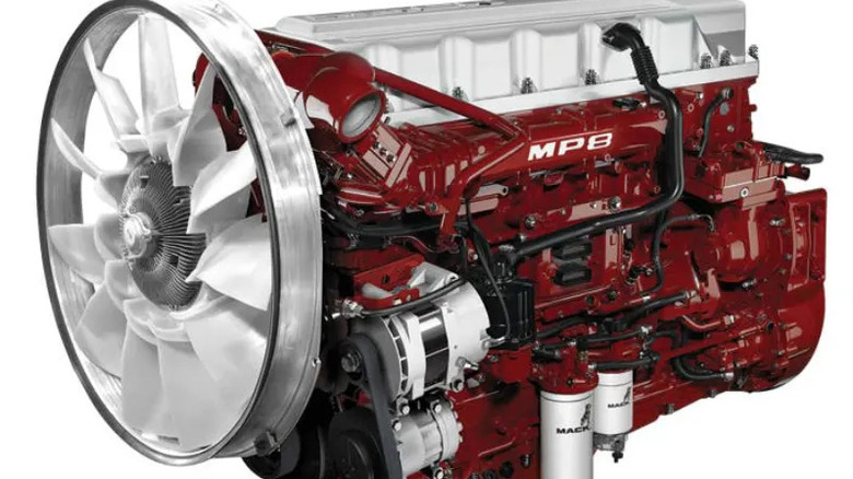 A red Mack MP8 diesel engine with visible fan, belts, and components, designed for use in heavy-duty trucks.