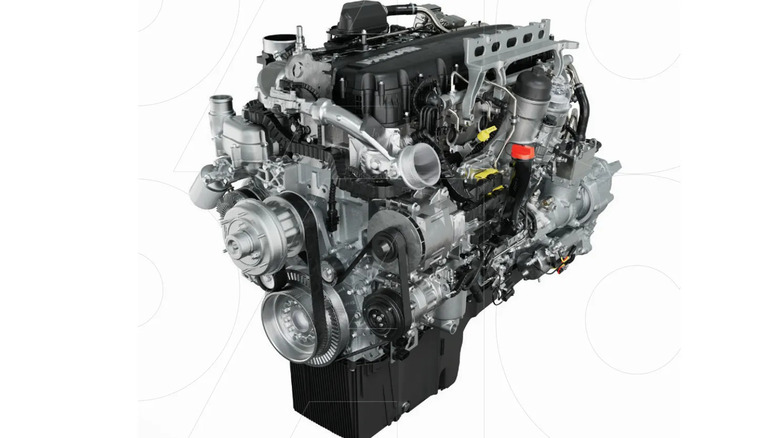 A detailed image of a modern diesel truck engine with visible turbocharger, serpentine belts, fuel lines, and cooling system components.