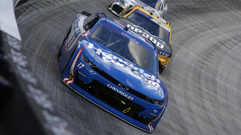 Blue chevrolet nascar taking a turn on track