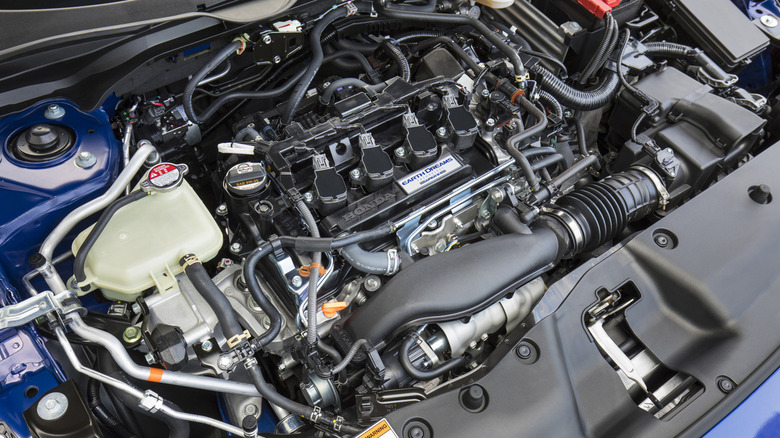 The engine bay of a blue 2017 Honda Civic SI, showing the L15B7 engine that came standard that year.