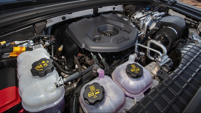 A clear view of the 2.0L I4 DOHC Turbo PHEV engine beneath the hood of a vehicle.