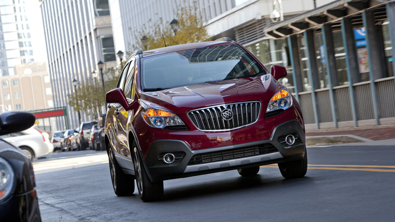 Red 2013 Buick Encore on a city street