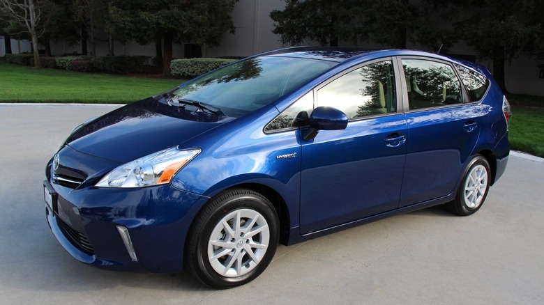 Blue 2014 Toyota Prius v parked on concrete