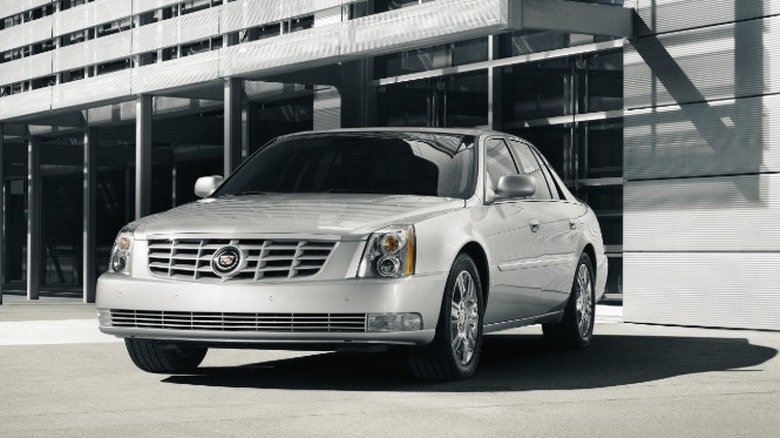 A 2011 Cadillac DTS in front of a building
