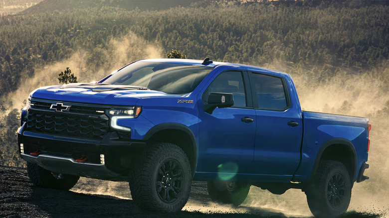 A blue Chevy Silverado driving on some hills