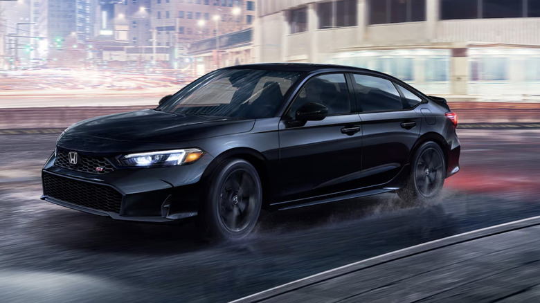 A black Honda Civic on a city street