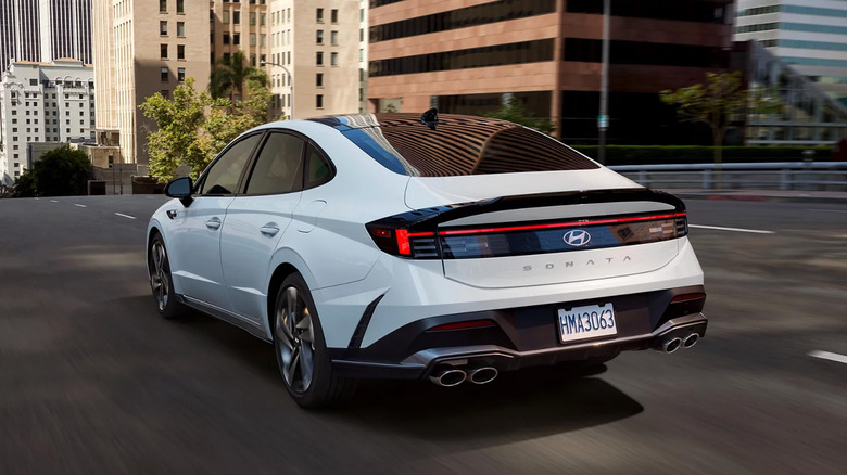 A white Hyundai Sonata driving in a city