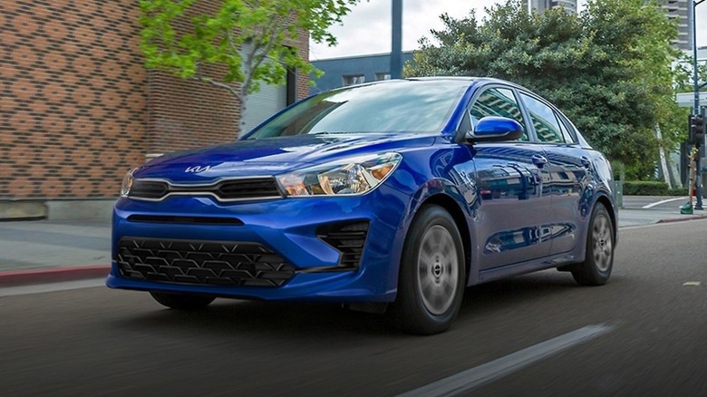 A Kia Rio against a natural backdrop, front three-quarters view left