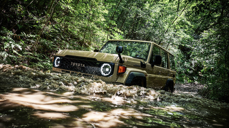 2024 Toyota Land Cruiser 70 Series driving through deep water