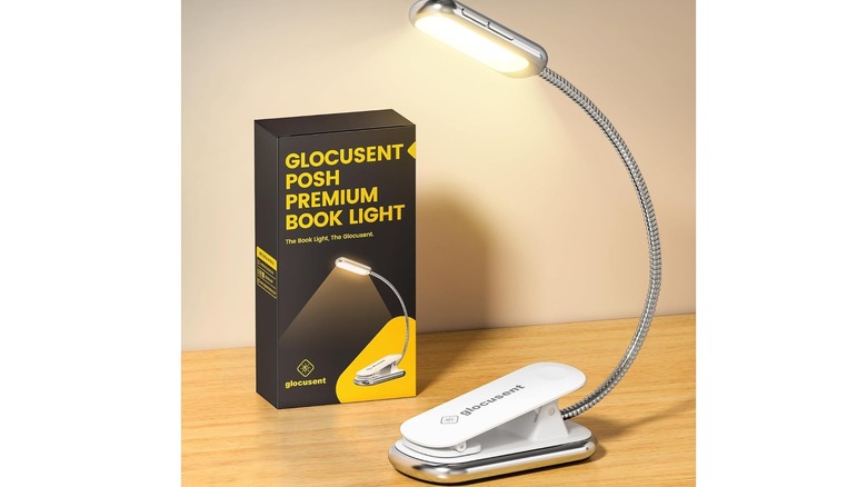 White book light on a table next to product packaging