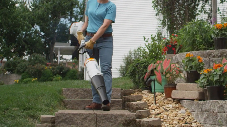 Woman using Stihl BG-KM Blower