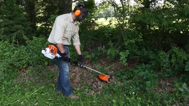 Man uses Stihl FS-KM Brushcutter