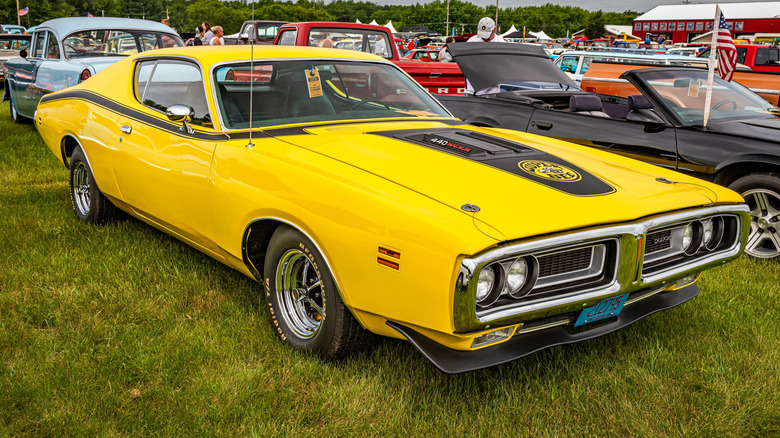 A Dodge Super Bee Hardtop Coupe being displayed in the shade at a car show