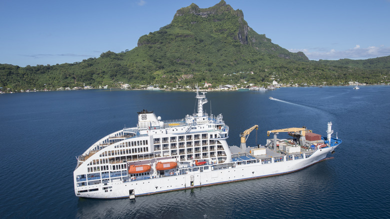Aranui 5 passenger/cargo ship seen from above right near a tropical island