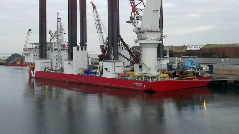 MPI Adventure ship at dock with jack-up legs and cranes all raised