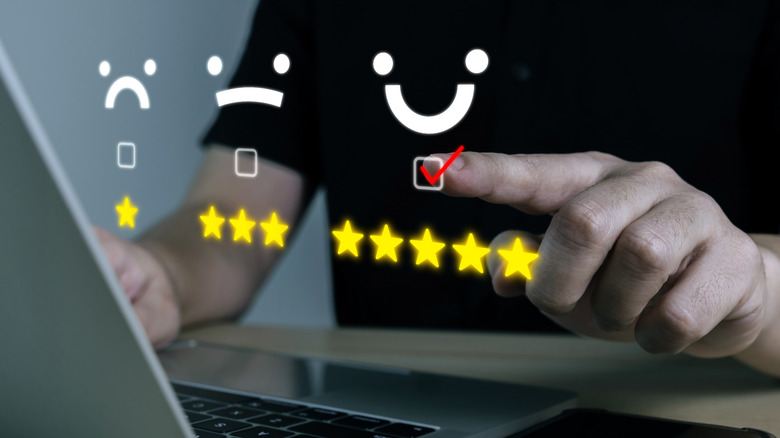 Holographic image of different star ratings and emoji icons.