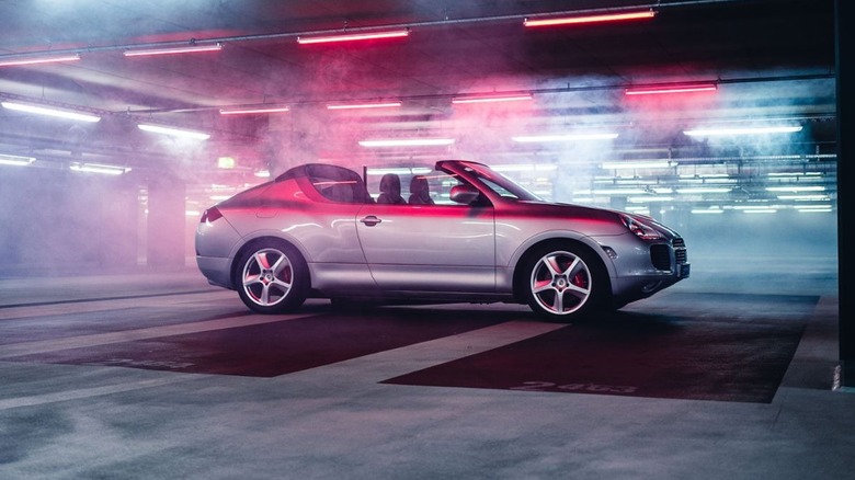 The Porsche Cayenne Convertible Concept in a neon-lit parking garage.