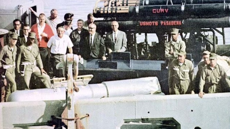 Crew gathered around a recovered nuclear weapon from the Palomares Incident
