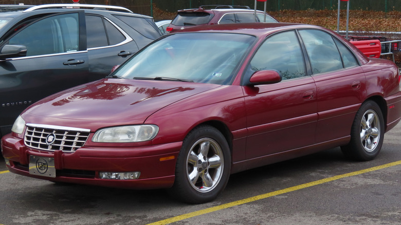 Red 1997 Cadillac Catera sedan seen from front left in a parking lot