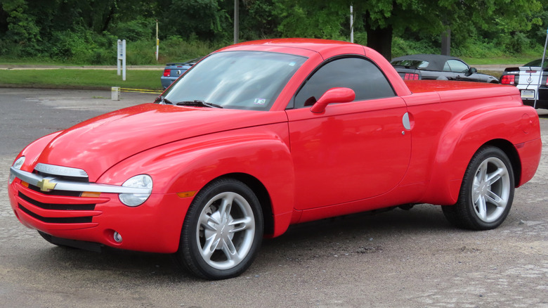Red 2004 Chevrolet SSR pickup truck seen from left front parked outdoors at a car show in New Castle, Pennsylvania