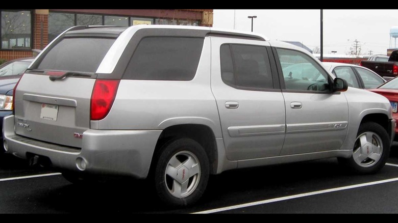 Gray GMC Envoy XUV seen from right rear in a parking lot