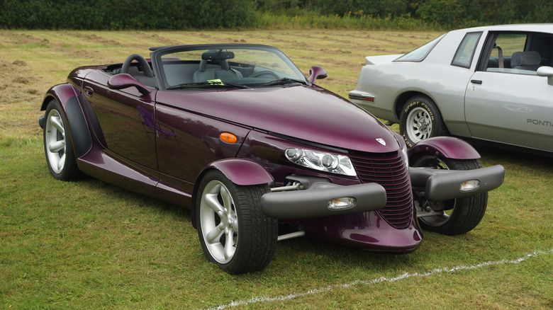 Purple 1999 Plymouth Prowler roadster seen from front right parked on grass