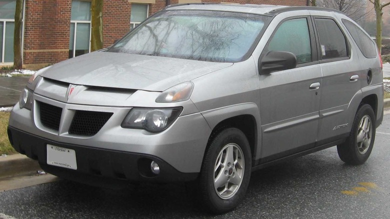 Gray Pontiac Aztek SUV seen from front left parked by a curb