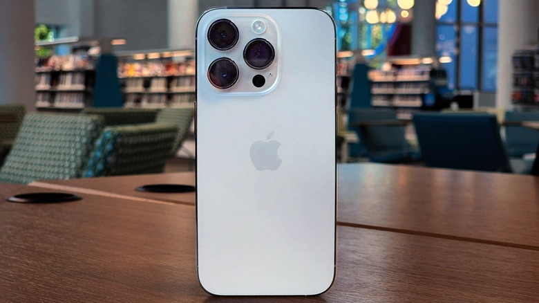 iPhone 14 Pro propped up vertically on a table