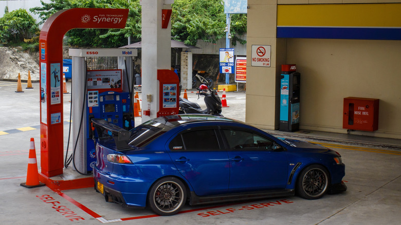 Blue Mitsubishi Lancer X at gas pump