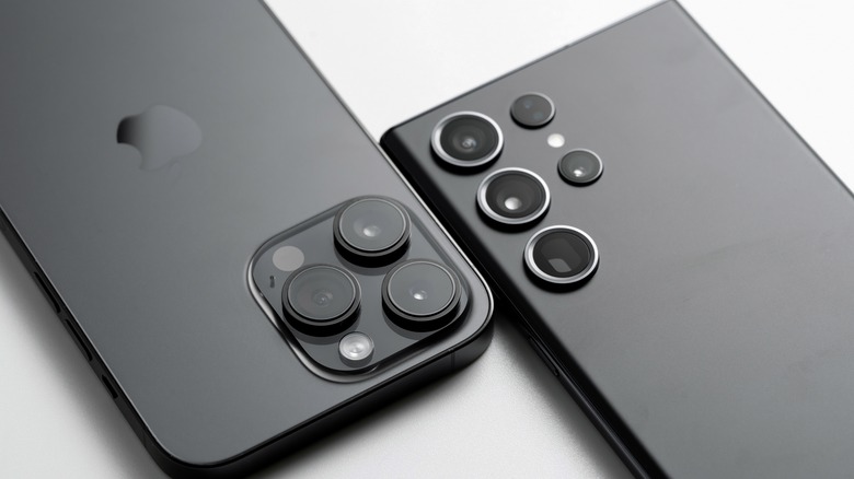 A Samsung Galaxy S23 Ultra and an iPhone 15 Pro next to one another