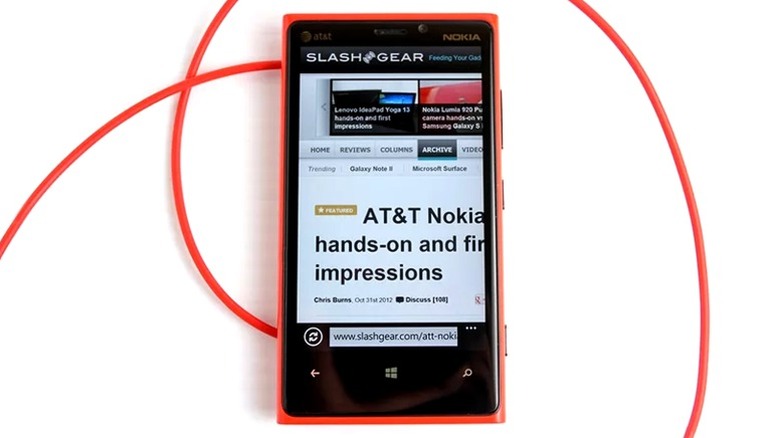 Nokia Lumia 920 and red charging cable on a white surface