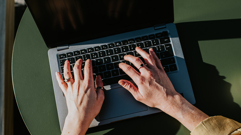 Typing on laptop