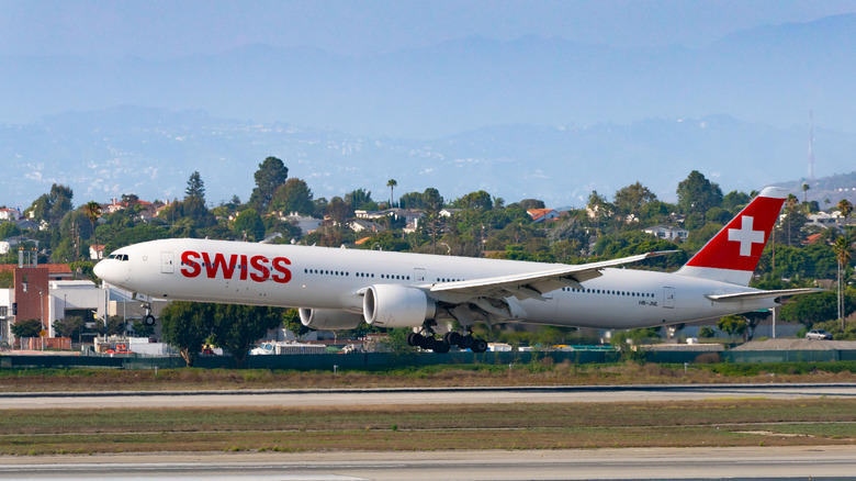 A swiss airlines Boeing 777-300 Extended Range plane arriving at Los Angeles international airport, right to left on Labor Day